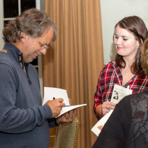 Mia Couto autographing a book.