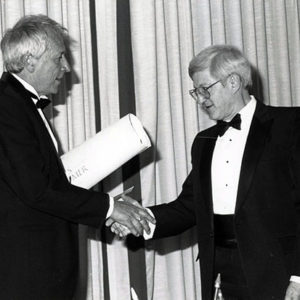 Tomas Tranströmer (left) receiving the Neustadt Prize certificate in June 1990.