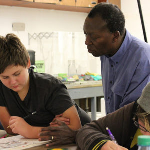 Meshack Asare speaking with a student