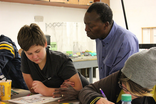 Meshack Asare speaking with a student